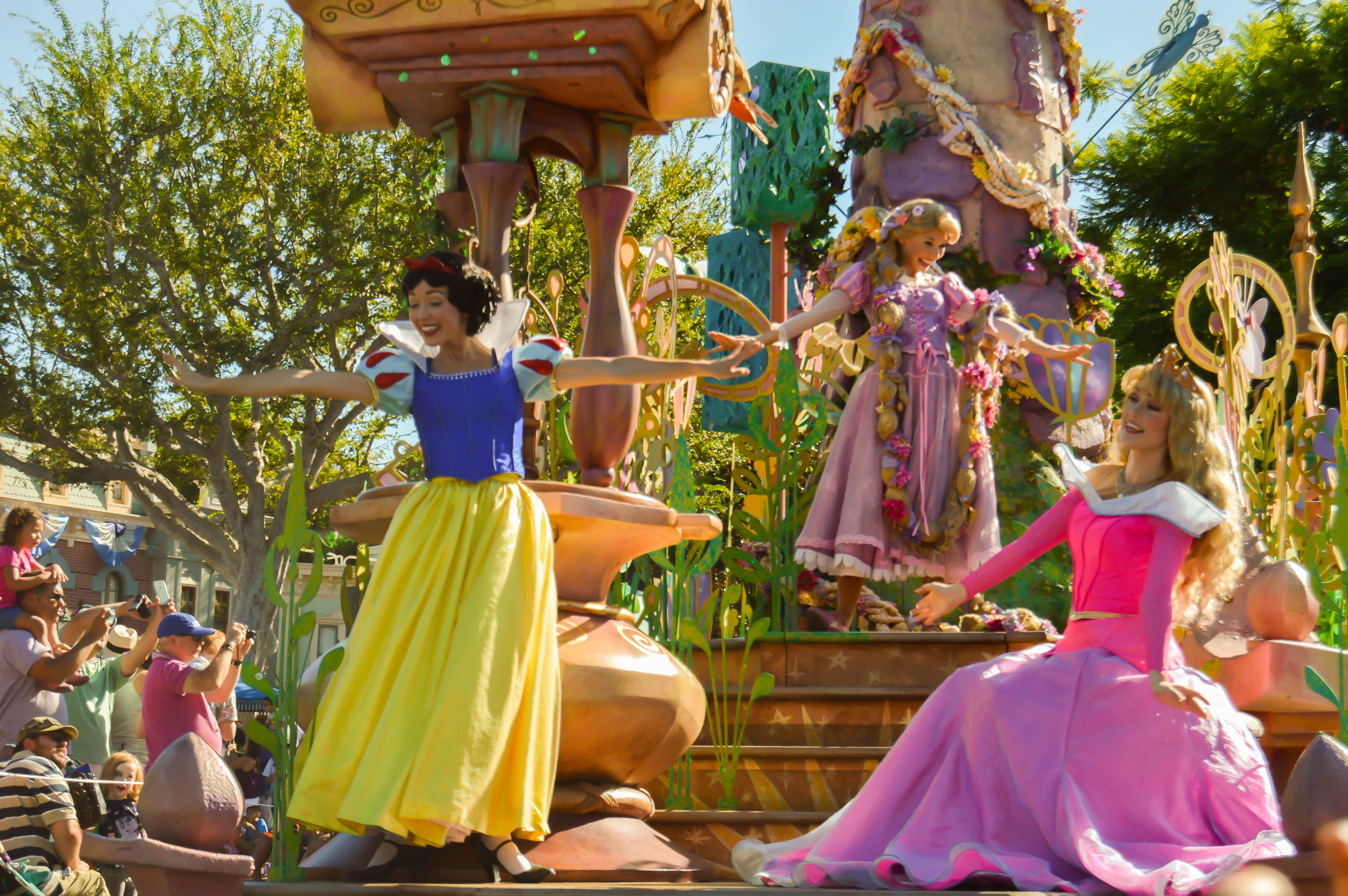 Rapunzel, Aurora, and Snow White on a float